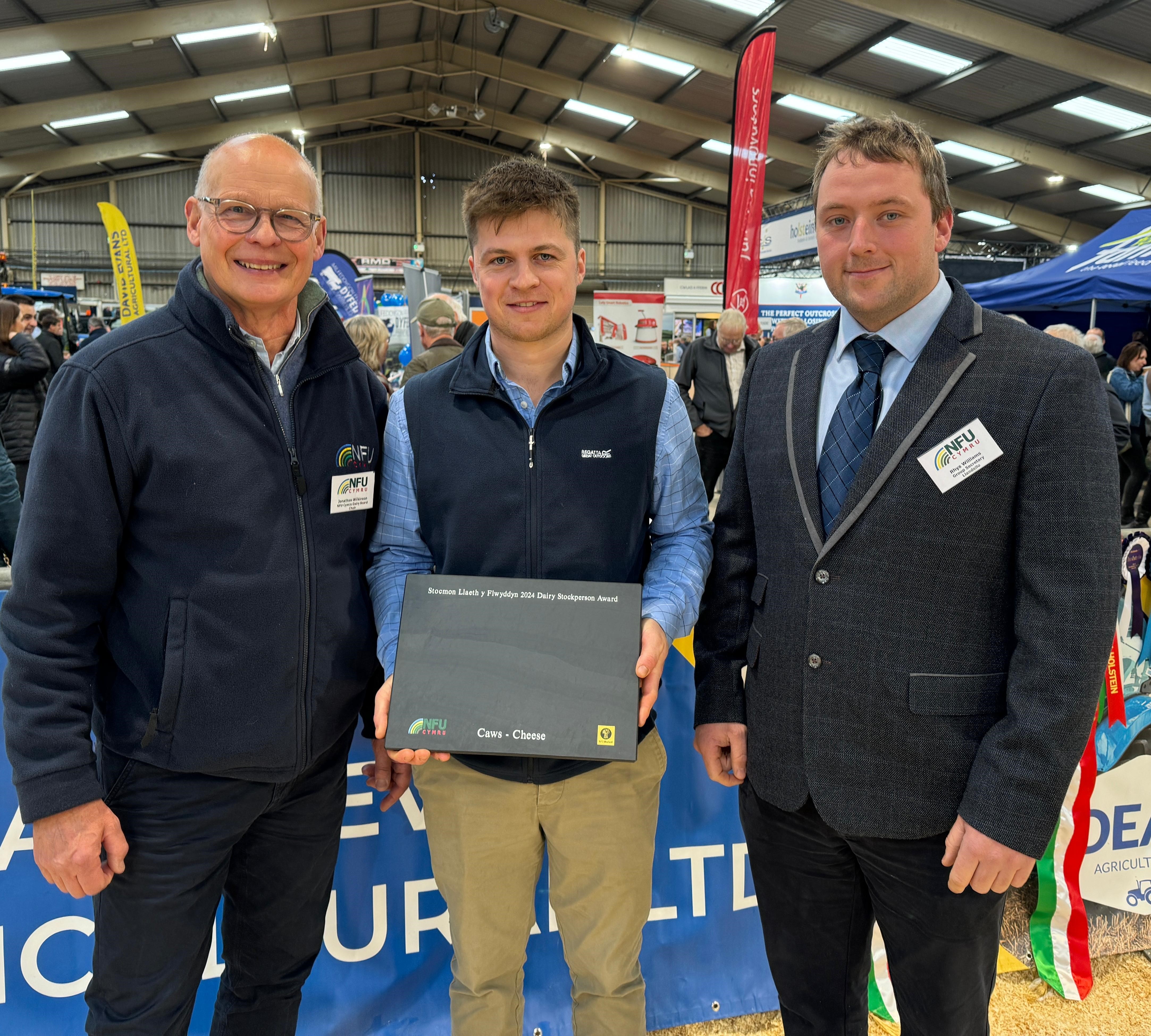 Pictured is NFU Cymru Dairy Board Chairman Jonathan Wilkinson, NFU Cymru / NFU Mutual Dairy Stockperson of the Year Award winner for 2024, William Davies and NFU Cymru / NFU Mutual Group Secretary, Rhys Williams 